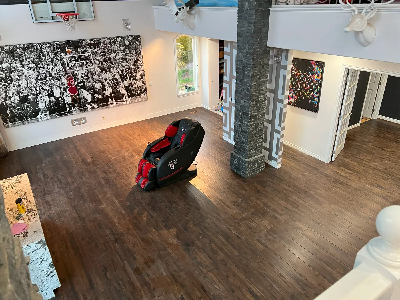 Dark plank flooring in a Tulsa, OK game room with a feature column