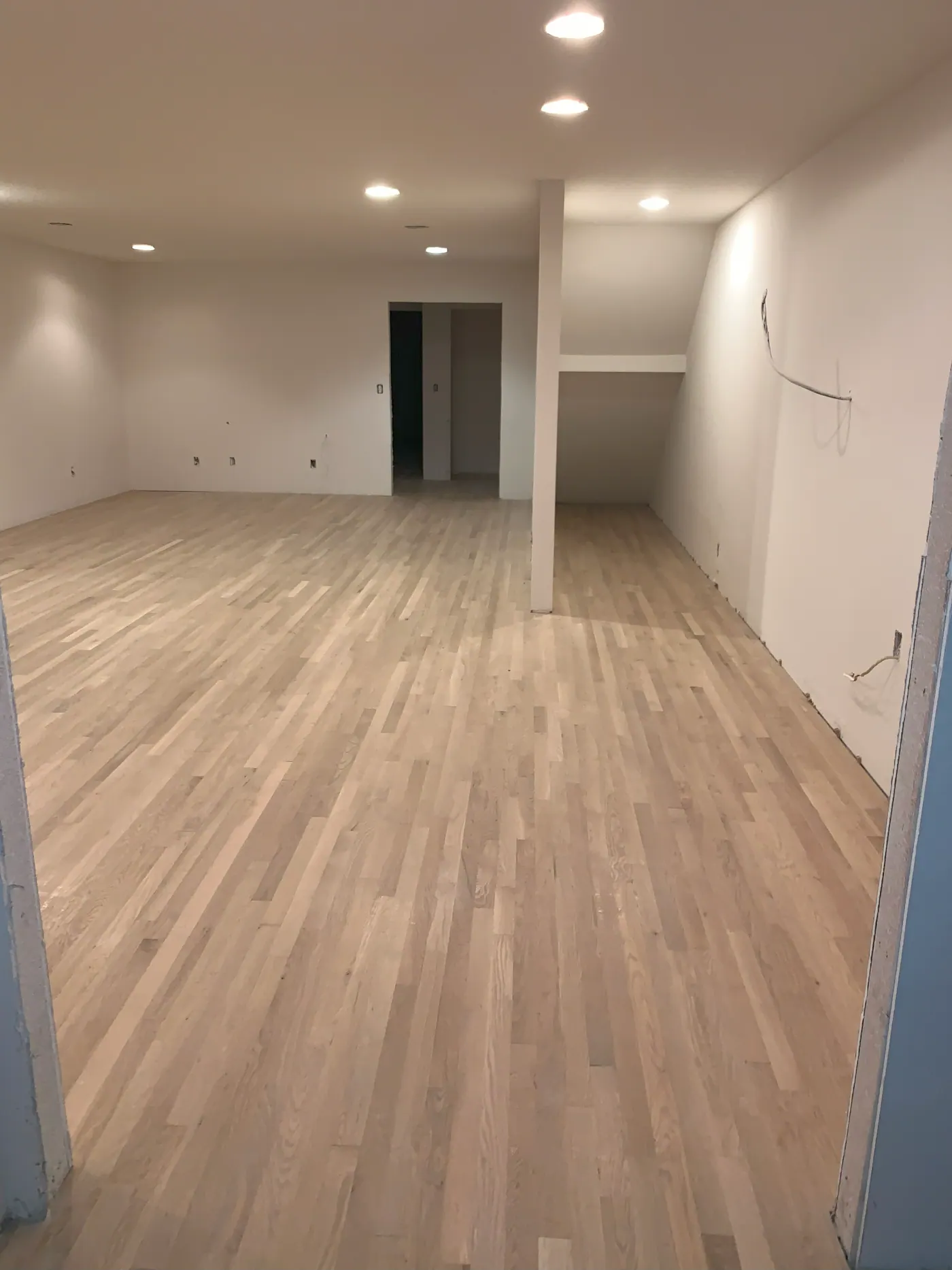 Light laminate flooring in an empty Tulsa, OK room ready for handover