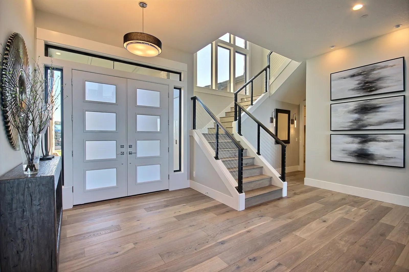 Plank flooring running through an entryway to a staircase in a Tulsa, OK home