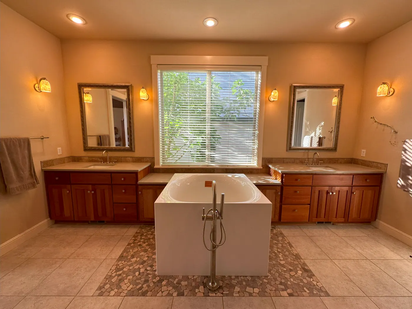 Tile bathroom floor set around a freestanding tub in a Tulsa metro home