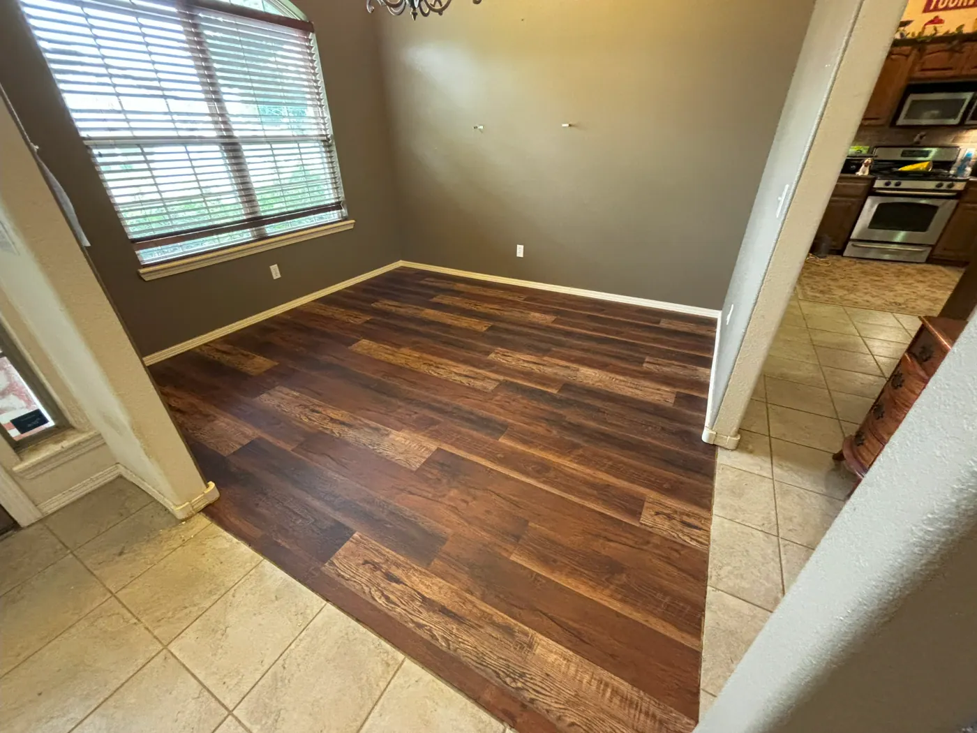 Flush hardwood to tile transition cut in a Tulsa, OK home by Foursquare Flooring
