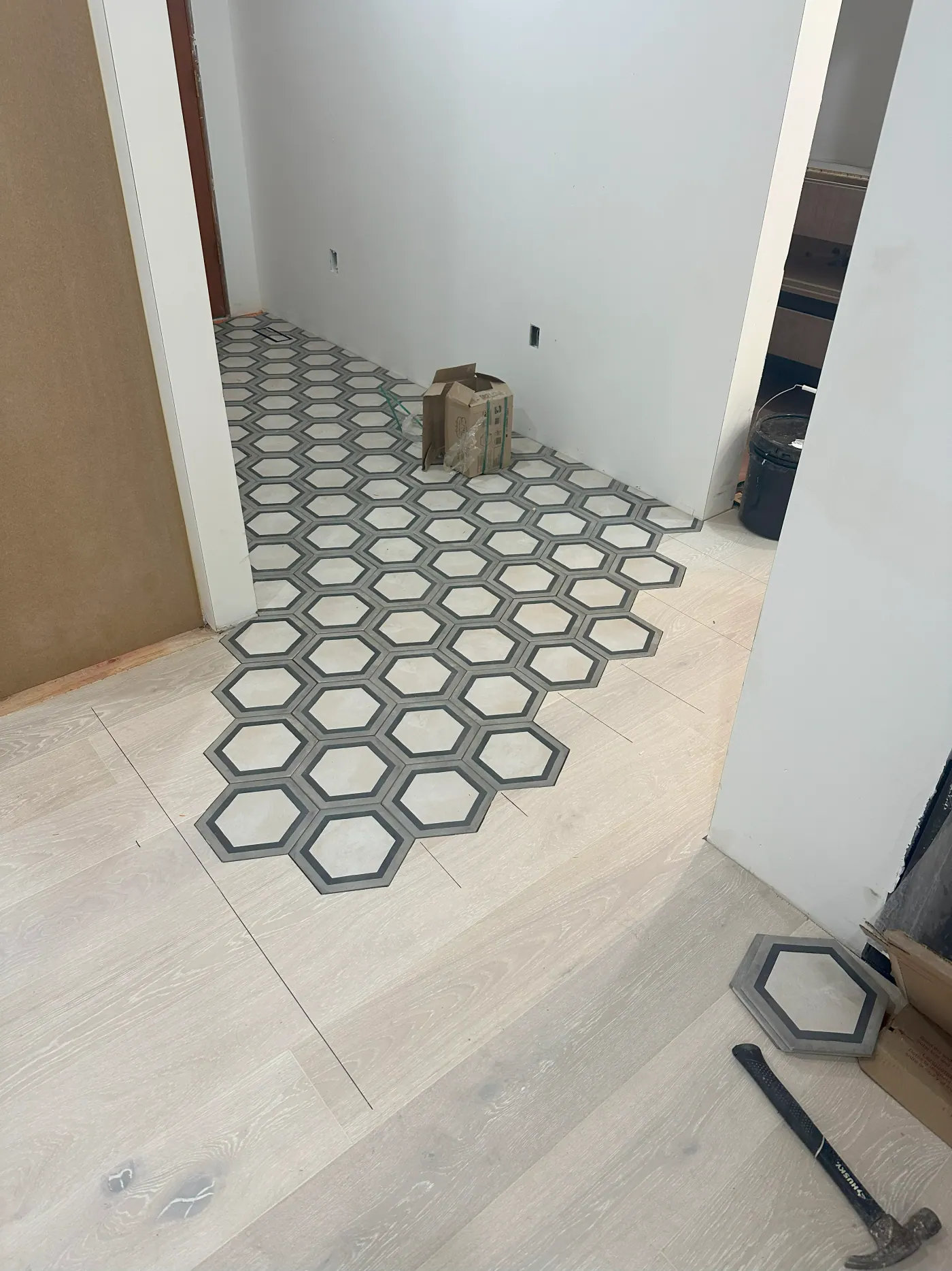 Hexagon tile floor installation in progress in a Tulsa, OK bathroom