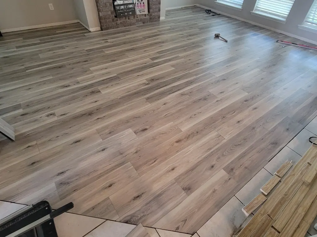 Laminate flooring installed up to a tile transition in a Tulsa, OK home
