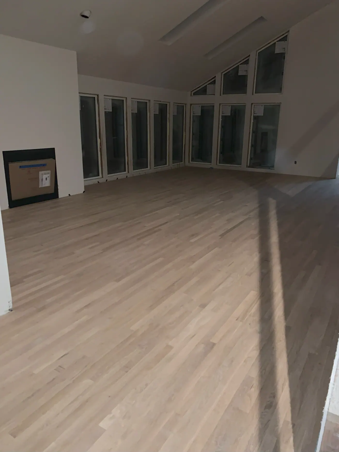 Light plank flooring installed through a large open room in a Tulsa, OK home