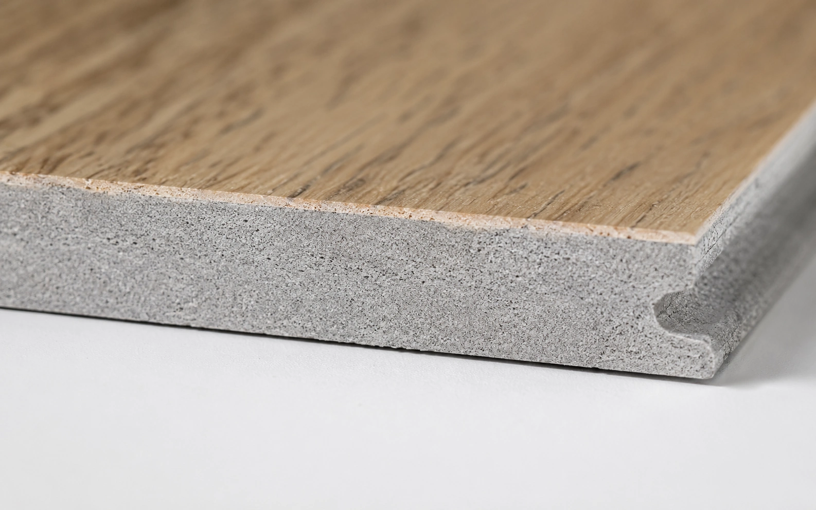 Close up of an SPC luxury vinyl plank edge showing its dense stone polymer core