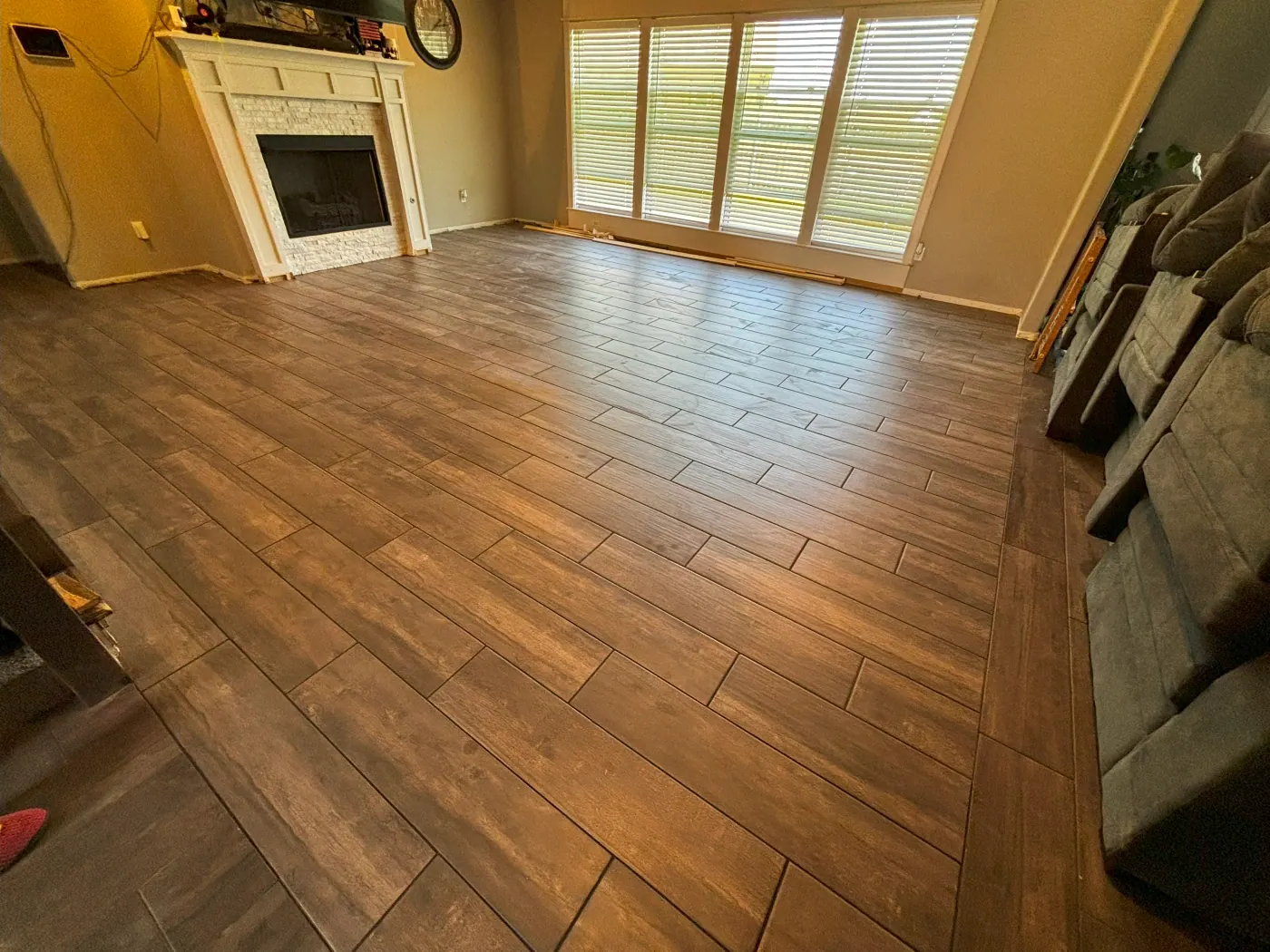 Wood look plank tile flooring in a Tulsa, OK living room installed by Foursquare Flooring